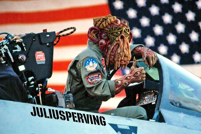 A stylized image of a Bored Ape-like creature wearing a pilot's flight suit and patches, sitting in a cockpit in front of an American flag with 'JULIUSPERVING' text displayed on the aircraft.
