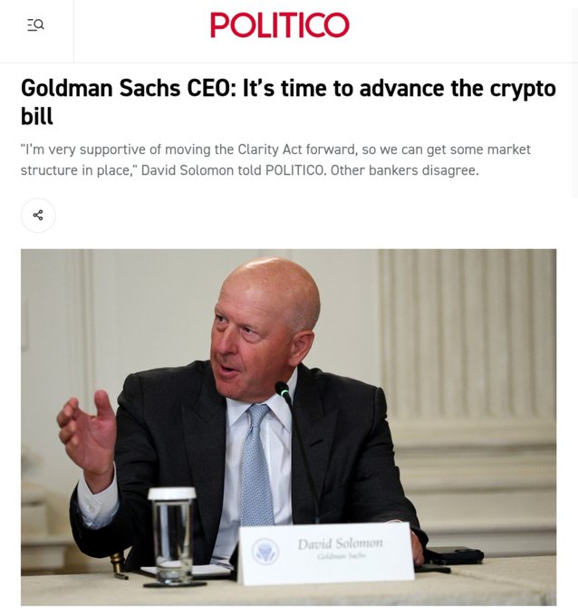 A POLITICO article features Goldman Sachs CEO David Solomon speaking at an event with his name placard visible, shown alongside the headline "Goldman Sachs CEO: It's time to advance the crypto bill" and a quote supporting moving the Clarity Act forward to establish crypto market structure. The image directly illustrates the accompanying post about Solomon advocating for the CLARITY Act, as the photograph captures him mid-speech while the headline reflects his pro-crypto regulatory stance.