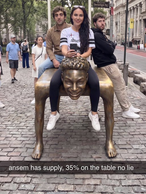 Three people pose on a bronze sculpture of a crawling figure with a smiling face on a cobblestone street near a sign for "Flammable" (likely "Flammable Way"), while the caption references carrying the weight of Solana and tags @notthreadguy, @mikadontlouz, and @rasmr_eth. The overlaid text reads "ansem has supply, 35% on the table no lie," tying the humorous image to a bold claim about token supply distribution.