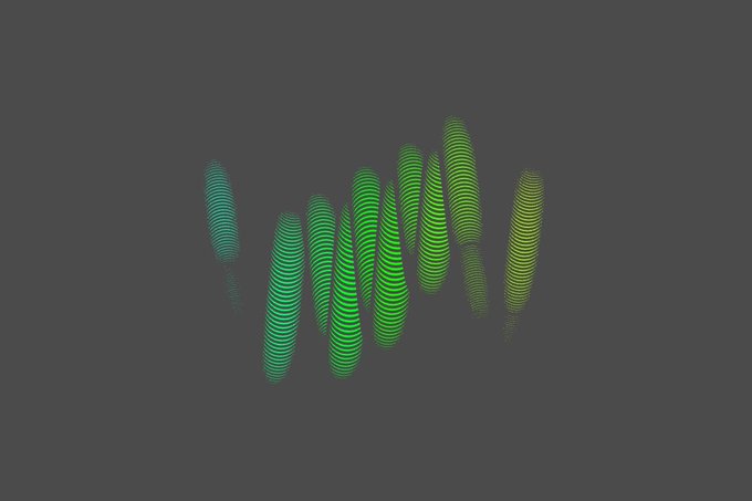 A dark image with abstract green circular/wavy light patterns, possibly from a concert lighting effect.