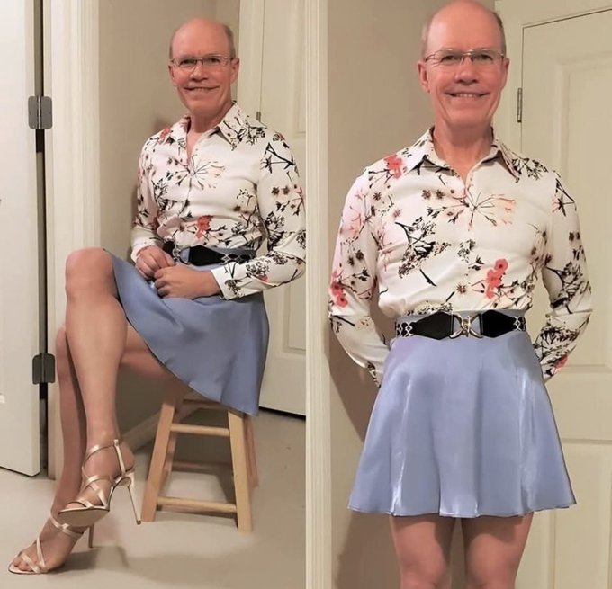 A side-by-side comparison of a bald man with glasses posing in a floral button-up shirt and lavender skirt, shown seated and standing.