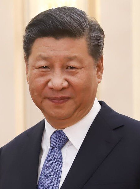 This image shows Xi Jinping, the President of the People's Republic of China, a key figure in the BRICS alliance that aims to challenge the dollar's global reserve currency status. The post suggests this monetary "war" is prompting America to move its financial system "on-chain".