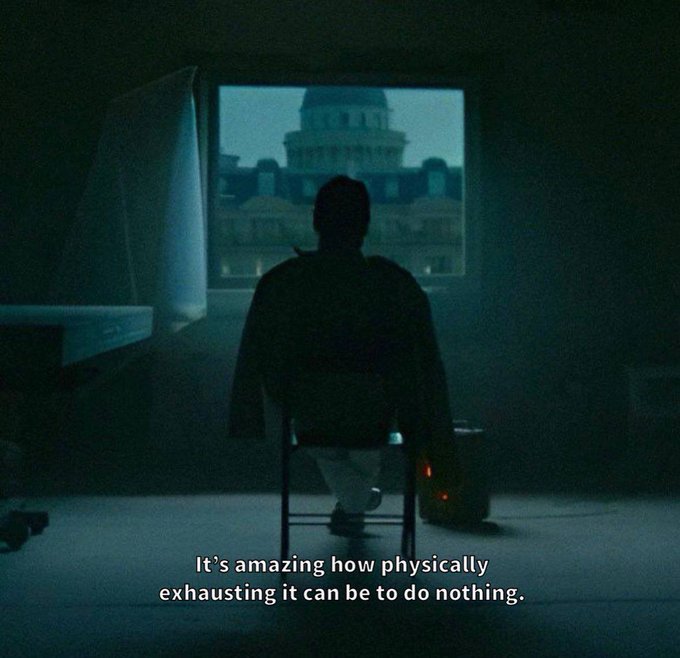 A silhouetted figure sits in a chair facing a window displaying the U.S. Capitol building, with the caption "It's amazing how physically exhausting it can be to do nothing." The dim, moody scene reflects the post's theme of idle weariness associated with "Marscoin Stonkbroker 哈基米."