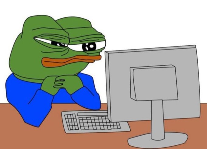 A cartoon drawing of a sad green Pepe the Frog character in a blue shirt staring at a gray computer monitor on a desk.