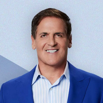 A smiling Mark Cuban, wearing a blue suit jacket over a striped shirt, is shown in a professional headshot. The image accompanies a news post about his recent statement comparing AI chips to a new asset class like cryptocurrency.