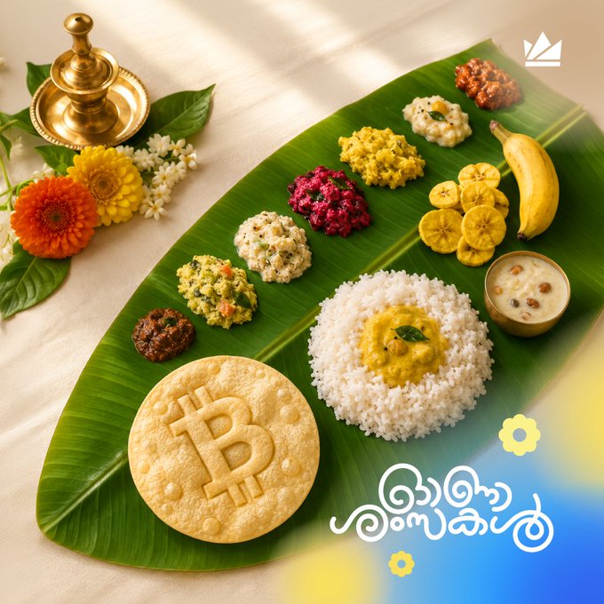 A traditional Onam Sadhya feast is elegantly arranged on a banana leaf, featuring white rice with dal, appam stamped with a Bitcoin-style "₿" symbol, sliced bananas, various curries, and payasam, accompanied by a brass lamp and marigold flowers. The Sinhala text "ආදරණීය ඔනාම්" (Beloved Onam) appears alongside a crown logo, celebrating the festival.