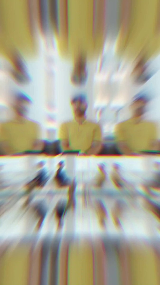 The image shows a blurry photo of two people wearing yellow shirts with one person's face being more prominent than the other. The background appears to be a blurred room, which adds to the overall fuzzy appearance of the picture. The caption provided seems unrelated to the image and does not provide any useful information about the content or context of the photograph.