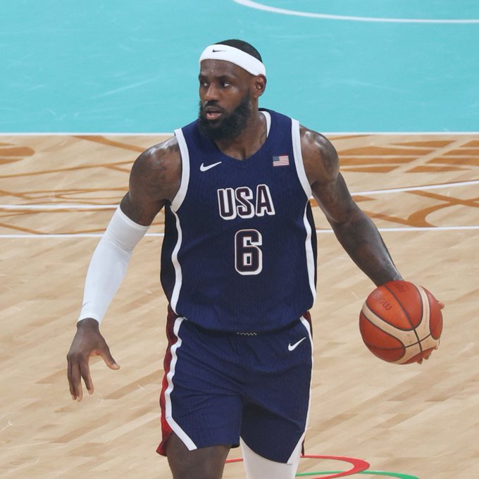 LeBron James, wearing a Team USA jersey with the number 6, dribbles a basketball on the court during an international game, with the accompanying post announcing his upcoming Polymarket partnership.