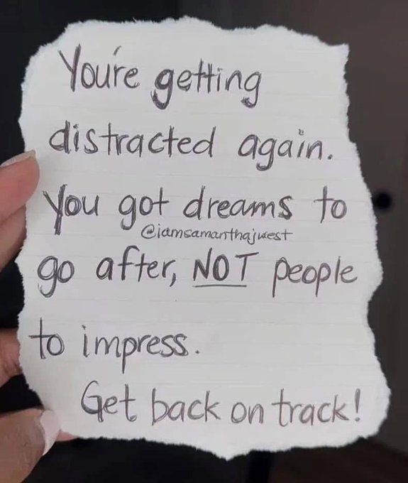 A hand holds a torn piece of paper with a handwritten motivational message that reads: "You're getting distracted again. You got dreams to go after, NOT people to impress. Get back on track!" signed "@iamsamanthajwest".