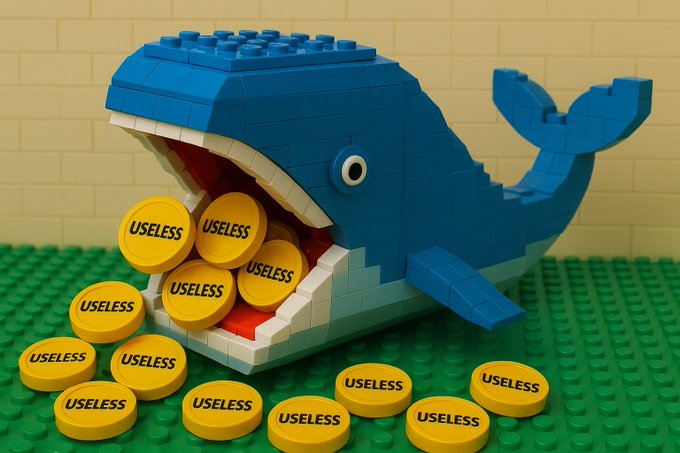 A photograph of a blue Lego whale with an open mouth, spilling and surrounded by yellow Lego round tiles printed with the word 'USELESS'.