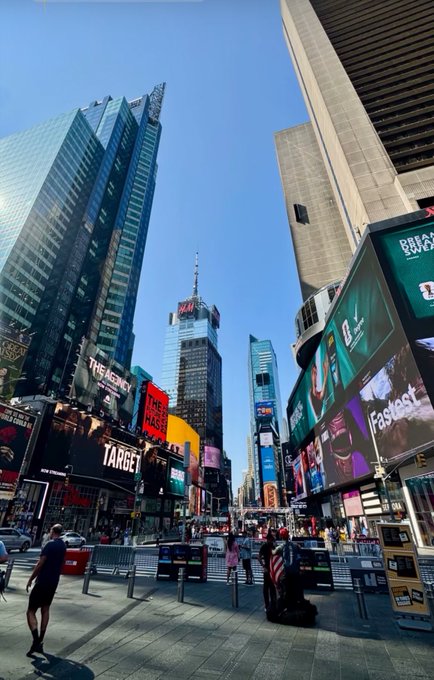 A bustling view of Times Square in New York City, featuring bright billboards advertising Target and "The Masked Singer," with crowds of pedestrians navigating the busy street under a clear blue sky.

The image of Times Square, a major hub of activity and connection, complements the post's call to actively network and grow, fittingly symbolizing the bustling exchange and community engagement the "GM if you GM" prompt seeks to inspire.