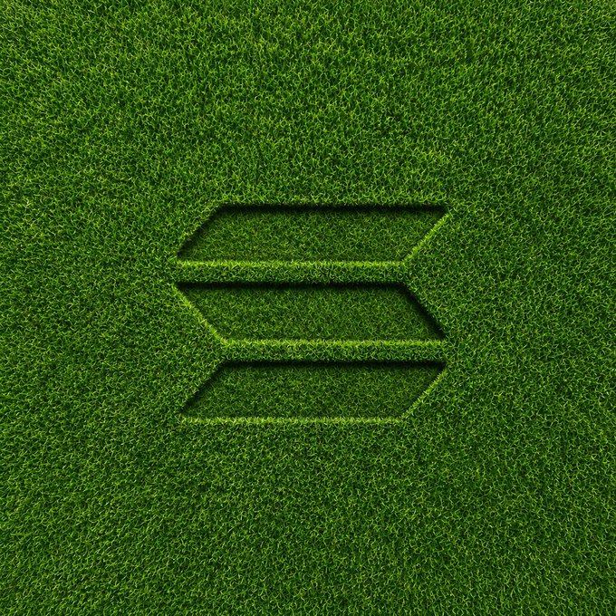 A stylized "S" logo (resembling Solana's branding) is cut into a field of lush green grass, visually playing on the post's advice to "touch grass" while highlighting Solana as the focal point of the upcoming big week.
