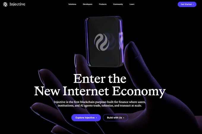 The Injective website homepage featuring a hand holding a black cube, with the text 'Enter the New Internet Economy' and buttons for 'Explore Injective' and 'Build with Us'.