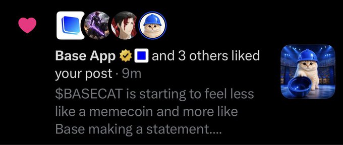 The image shows a social media post notification where Base App and 3 others liked a post that reads "$BASECAT is starting to feel less like a memecoin and more like Base making a statement...." Alongside the notification, there's an image of a cat wearing a blue construction hat surrounded by blue hard hats, representing the $BASECAT mascot. This relates to the caption by confirming that the Base App officially liked the user's theory about $BASECAT being more than just a typical memecoin.