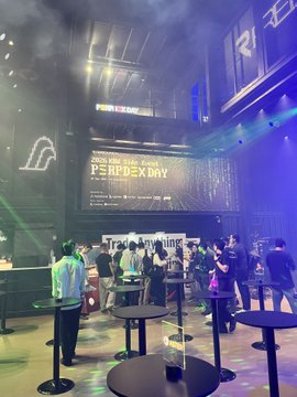A Trade Anything event at Perfexpo in Singapore, showing attendees mingling in a lounge with high tables, laser lights, and stage signage.