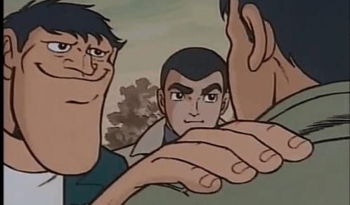 A classic anime screenshot showing three characters, with the central character looking intensely forward.