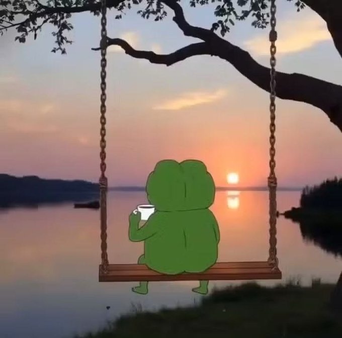 A whimsical illustration of a green frog character sitting on a wooden swing, holding a small white cup while gazing at a serene sunset over a calm lake.