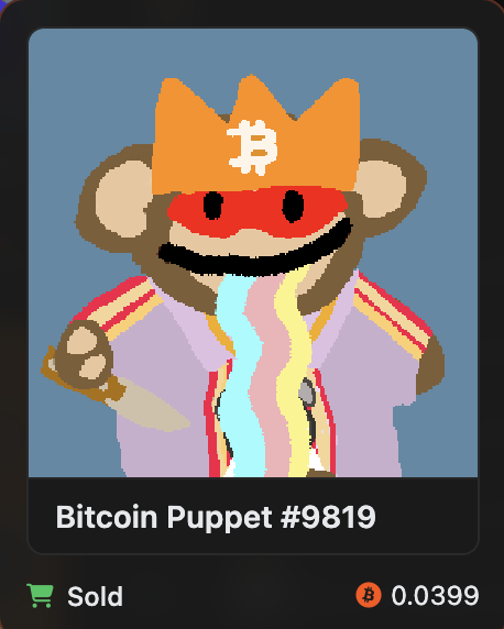 A digital NFT card labeled "Bitcoin Puppet #9819" showing a cartoon puppet wearing an orange crown with the Bitcoin symbol, marked as Sold for 0.0399 BTC.