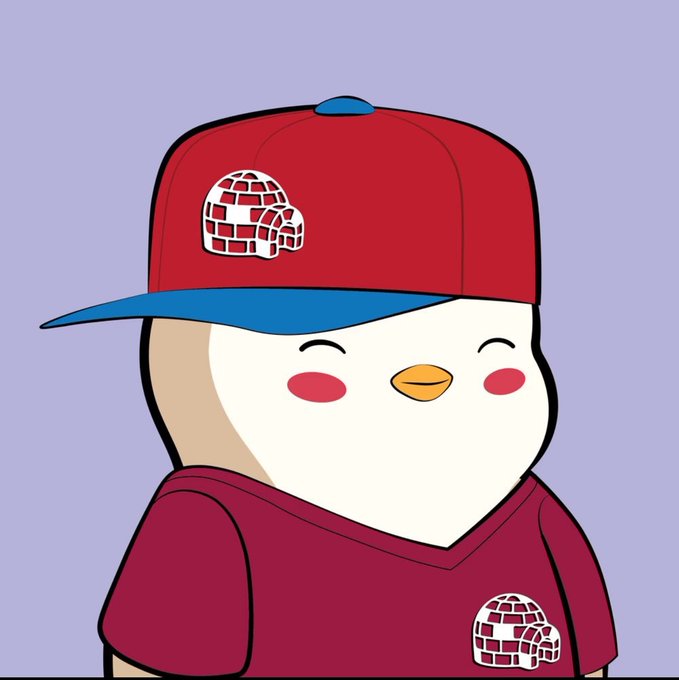 A cartoon penguin wearing a red and blue baseball cap with an igloo logo and a matching maroon shirt featuring the same igloo emblem, set against a light purple background. The igloo branding suggests it's PUDGY PENGUINS, a popular NFT collection, fitting the post's theme about navigating the fast-paced crypto/NFT space.