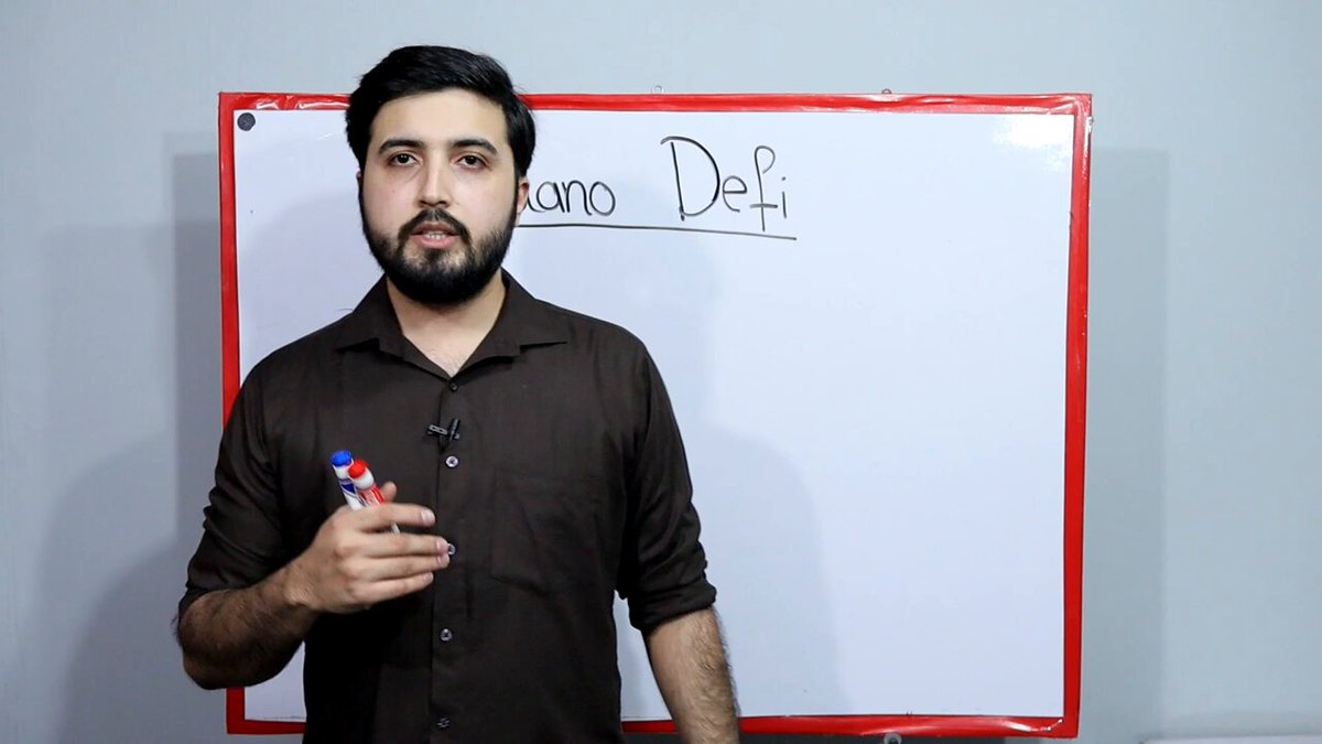 The image shows a man standing next to a whiteboard, holding a marker and pointing at it. The text "Cardano DeFi TVL" can be seen written on the board. The caption of the image reads, "Why Cardano DeFi TVL could explode 10x: Cardano has the best staking mechanism in crypto... but it's oddly holding back DeFi growth". This statement suggests that the man is discussing the potential growth and impact of Cardano DeFi on the market.