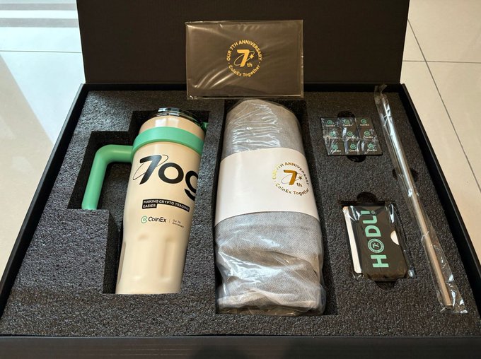 A CoinEx "7th Anniversary Creator's Gift" gift box is displayed, containing a branded travel tumbler with "1,000 USDT Voucher" text, a "HOdl" keychain, and what appears to be additional wrapped merchandise, representing the creator support program that helped the user begin posting on Twitter two years ago before the exchange announced its shutdown with withdrawals open until 2026/12/22 (UTC+8).