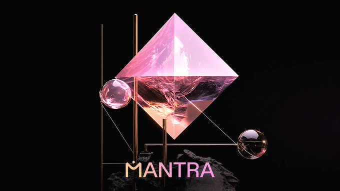 Stylized graphic featuring a pink crystalline diamond/prism structure with "MANTRA" text overlaid on a black background, accompanied by decorative spheres and gold rods.