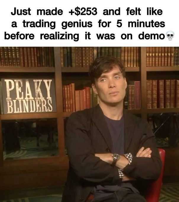 In the image, a man wearing a black suit jacket with arms crossed sitting at a desk near a bookshelf filled with numerous books. The title of an animated video featuring him can be seen below him. There are also two additional texts on the image that reference the show "Peaky Blinders" and make a funny joke about feeling like a trading genius before realizing it was worth five minutes to prove its relevance.