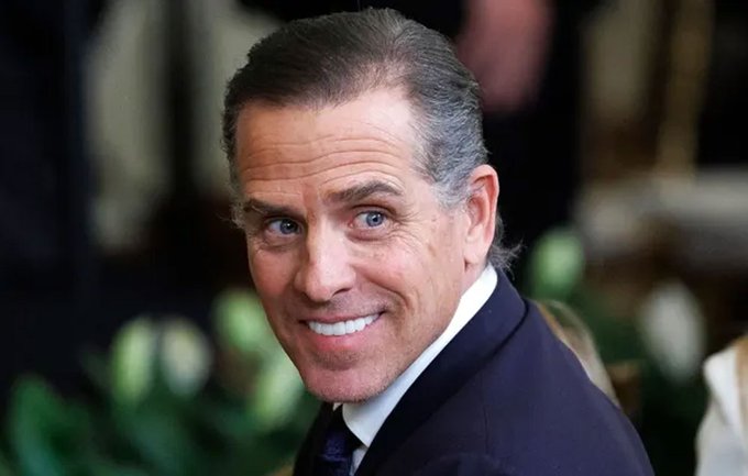 The image features a man wearing a suit and tie with short hair, smiling at the camera. The caption reads " Former President Joe Biden's son, Hunter Biden" which suggests that the photo might be related to a discussion or interview about the former president's views on Hyper Liquid technology.