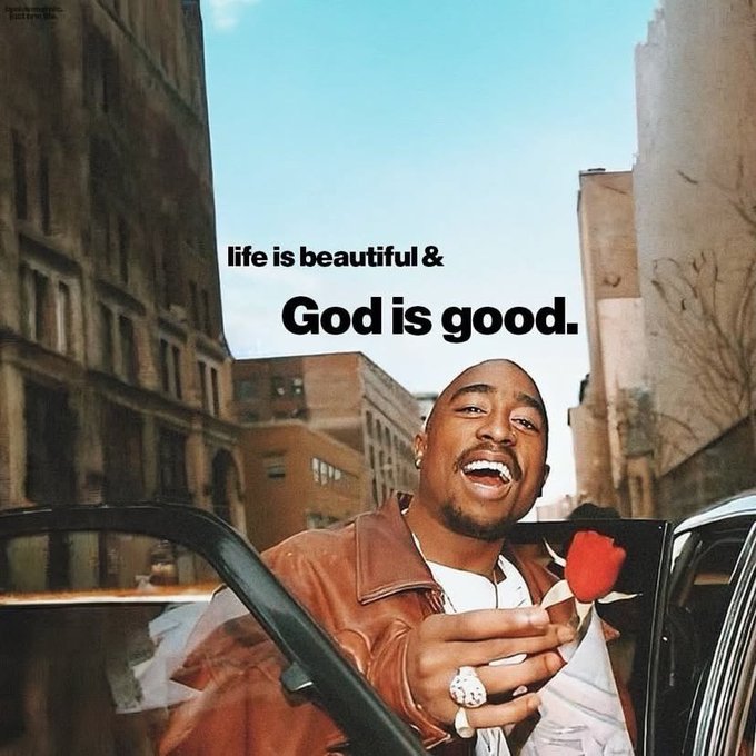 An inspirational meme featuring Tupac Shakur in a brown leather jacket holding a red rose, with text overlay reading "life is beautiful & God is good."