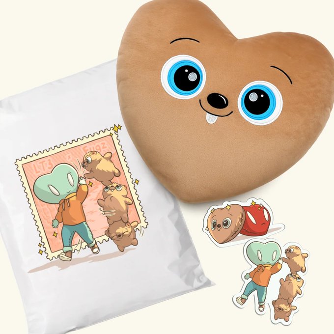 Merchandise merchandise featuring a cute brown heart-shaped pillow with blue eyes, alongside a t-shirt and stickers displaying similar cartoon character designs including a heart and a rabbit-like figure.