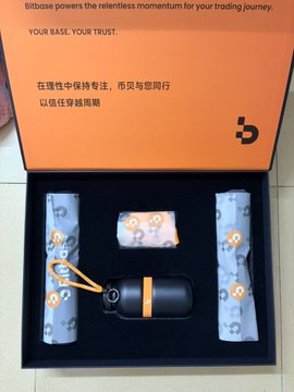 A promotional box for 'Bitbase' displays the tagline 'YOUR BASE, YOUR TRUST' alongside Chinese text, with a view of a black cylindrical device and two rolled patterned fabrics nestled inside.