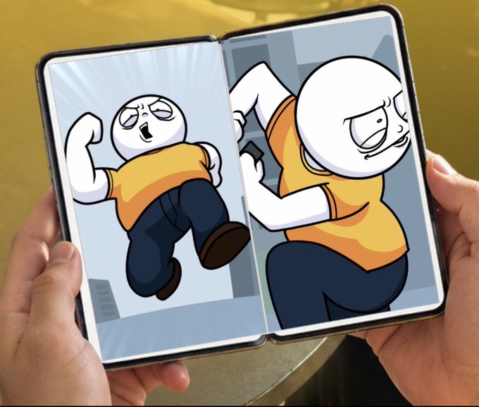 A pair of hands holding an unfolded dual-screen foldable device displaying cartoon characters wearing orange shirts and blue pants in action poses.