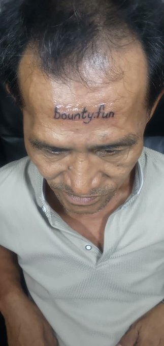 The image shows a man with a tattoo of "Crypto" written on his forehead, which is worth 200 dollars as a bounty. The post suggests that someone has won this bounty by entering a specific code or phrase related to cryptocurrency. This unusual and creative approach to winning a bounty demonstrates the lengths people are willing to go for potential rewards in the crypto world.