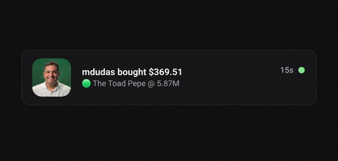 A notification card displays a profile photo of a smiling man next to the text "mdudas bought $369.51," with "The Toad Pepe @ 5.87M" listed below and a timestamp of "15s," confirming the purchase alert described in the post.