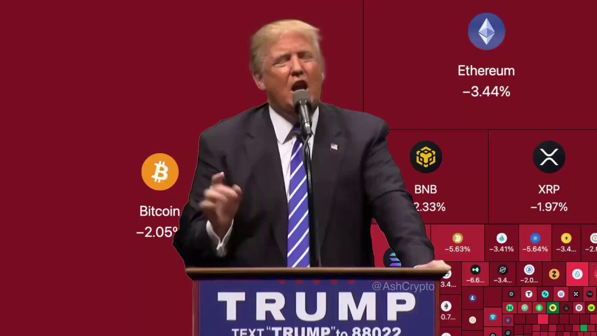 The image shows a man standing at a podium, giving a speech or presentation. The background of the image features a red wall with various logos and icons related to Bitcoin and Etherium. One of these icons displays the text "Text Trump" along with an image of Donald Trump. Another icon represents Bitcoin, while Etherium is represented by a blue square. The man at the podium has his hands in front of him, suggesting he might be delivering a speech or presentation about the cryptocurrency market.