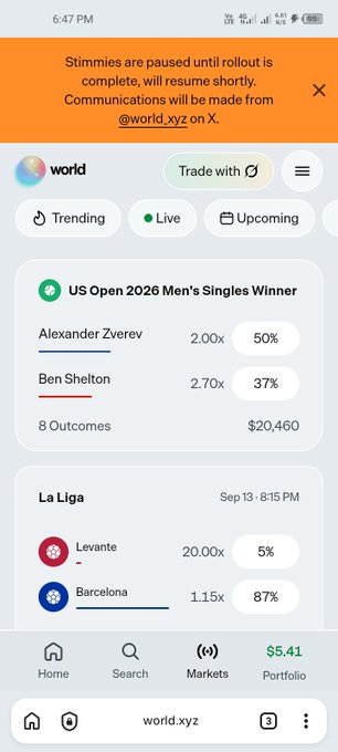 A screenshot of the world.xyz mobile app showing betting markets for 'US Open 2026 Men's Singles Winner' (Alexander Zverev 50%, Ben Shelton 37%) and 'La Liga' (Levante 5%, Barcelona 87%), with a notice that 'Stimmies are paused until rollout is complete.'