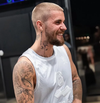 Justin Bieber, seen here smiling backstage, is favored at 72% odds on Polymarket to perform at the 2026 FIFA World Cup Final halftime show. His visible joy and casual attire suggest he's in good spirits amid the buzz surrounding the potential performance.