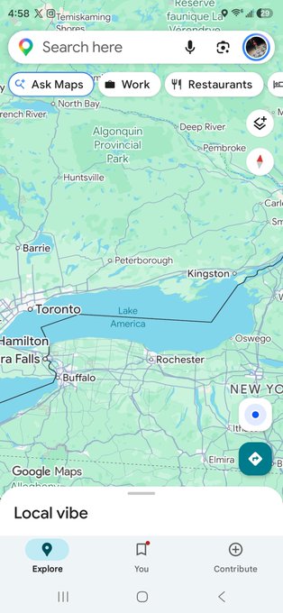 Screenshot of Google Maps on a phone showing the area around Toronto, Lake Ontario, Buffalo, and Rochester, with 'Ask Maps', 'Work', and 'Restaurants' filter buttons at the top.
