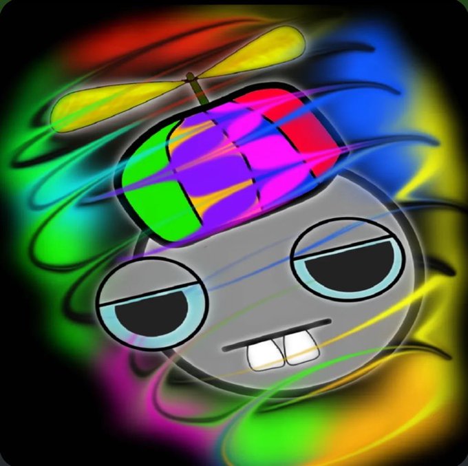 A cartoon-style character with a propeller beanie hat displaying a colorful checkered pattern, half-closed eyes, and buck teeth, surrounded by vibrant rainbow swirls — likely representing the "GEKIDO" meme coin mascot associated with the Gekido Collective project and its free mint airdrop campaign.