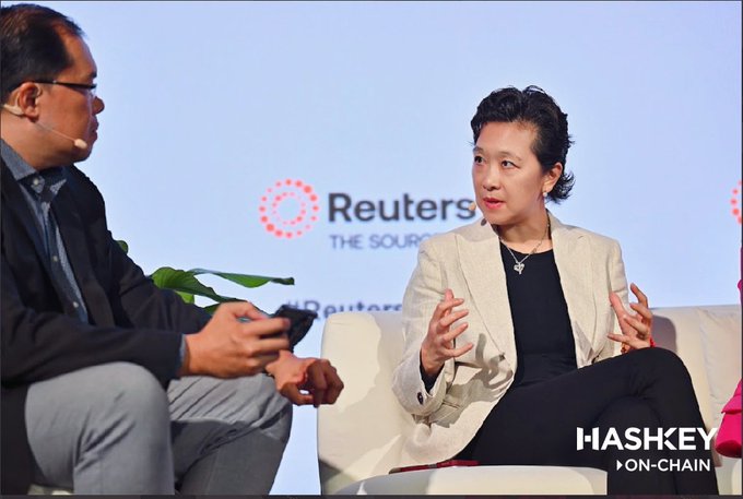 Rachel Qiu, Head of BD at HashKey Group and COO of HashKey On-Chain BG, speaks at a panel during Reuters NEXT Asia in Singapore on July 9, 2026, with the Reuters logo visible on the backdrop and a "HASHKEY ON-CHAIN" watermark in the corner, illustrating the conference's focus on institutional digital asset adoption and the future of on-chain finance in the region.