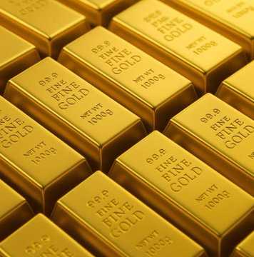 A close-up view of stacked gold bars, each stamped with markings indicating '999.9 FINE GOLD' and 'NET WT 1000g'.