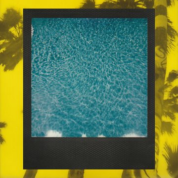 Artistic image showing a black-framed Polaroid-style photo of sparkling blue swimming pool water, set against a yellow background with palm tree silhouettes.