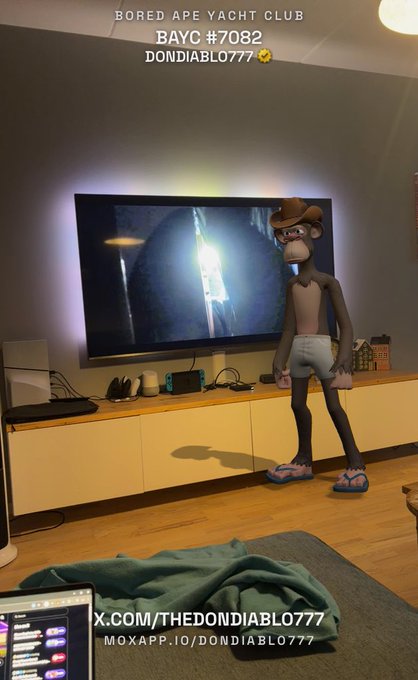 A Bored Ape Yacht Club NFT (#7082, dondiablo777) displayed as an augmented reality figure in a living room, shown in front of a television with a Nintendo Switch on the console below.