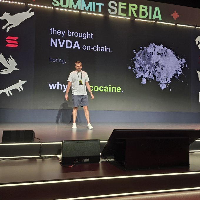 A man stands on stage at 'SUMMIT SERBIA' presenting a slide that reads 'they brought NVDA on-chain. why no cocaine.' next to an image of a white powder pile.