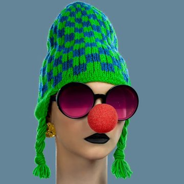 A mannequin head wearing a green and blue checkered knit hat with tassels, round purple-tinted sunglasses, and a red clown nose.