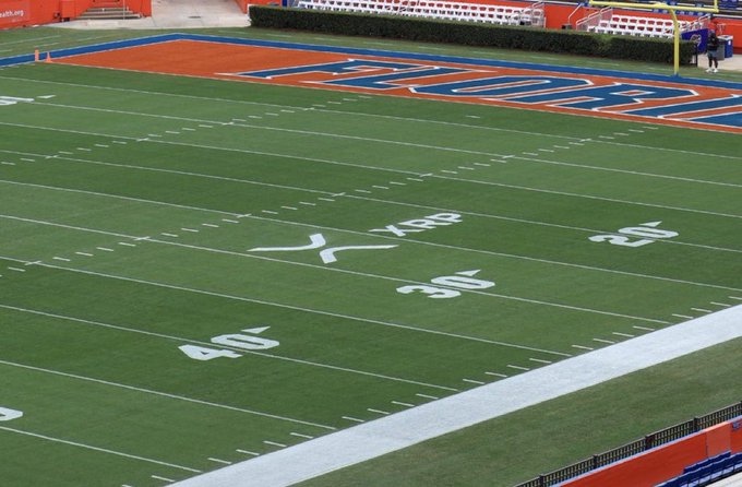 An American football field with yard lines showing 20, 30, and 40, featuring an orange end zone with blue lettering.