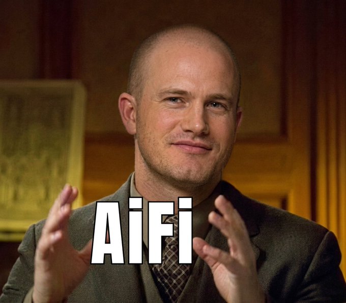 A bald man in a suit gestures with his hands in what appears to be a meme or reaction image, with the text 'AiiFI' overlaid in large white letters.