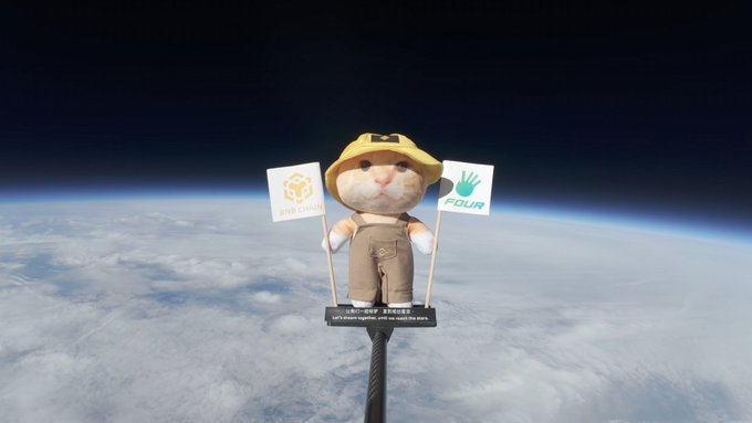 A plush hamster mascot wearing a safari hat holds two flags—one reading "FOUR" and another with a hand logo—mounted on what appears to be a camera against the backdrop of Earth's atmosphere from space.

The image satirizes the post's theme of crypto market dynamics, with the high-altitude "observation" symbolizing watching tokens pump from the sidelines, while the flags likely represent competing chains (Solana vs. BSC Chain) in the memecoin landscape the author describes.
