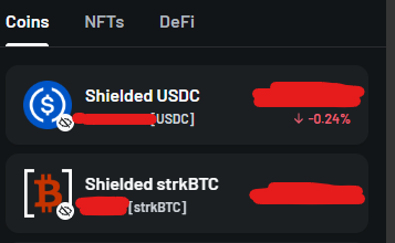 A screenshot of a crypto portfolio app showing assets under 'Coins', 'NFTs', and 'DeFi' tabs, with redacted asset amounts for 'Shielded USDC [USDC]' (down -0.24%) and 'Shielded strKBTC [strKBTC]'.