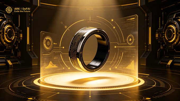 The image showcases a sleek black smart ring with circuit-like engravings, displayed within a futuristic golden holographic interface featuring data charts and tech-inspired graphics, with the "ARK | DeFAI - Code the Future" logo in the upper left corner. This visually represents the post's message of ARK's innovation and forward momentum, symbolizing how the Arkie AI App transforms user ideas into tangible progress and ecosystem growth through advanced AI agents.